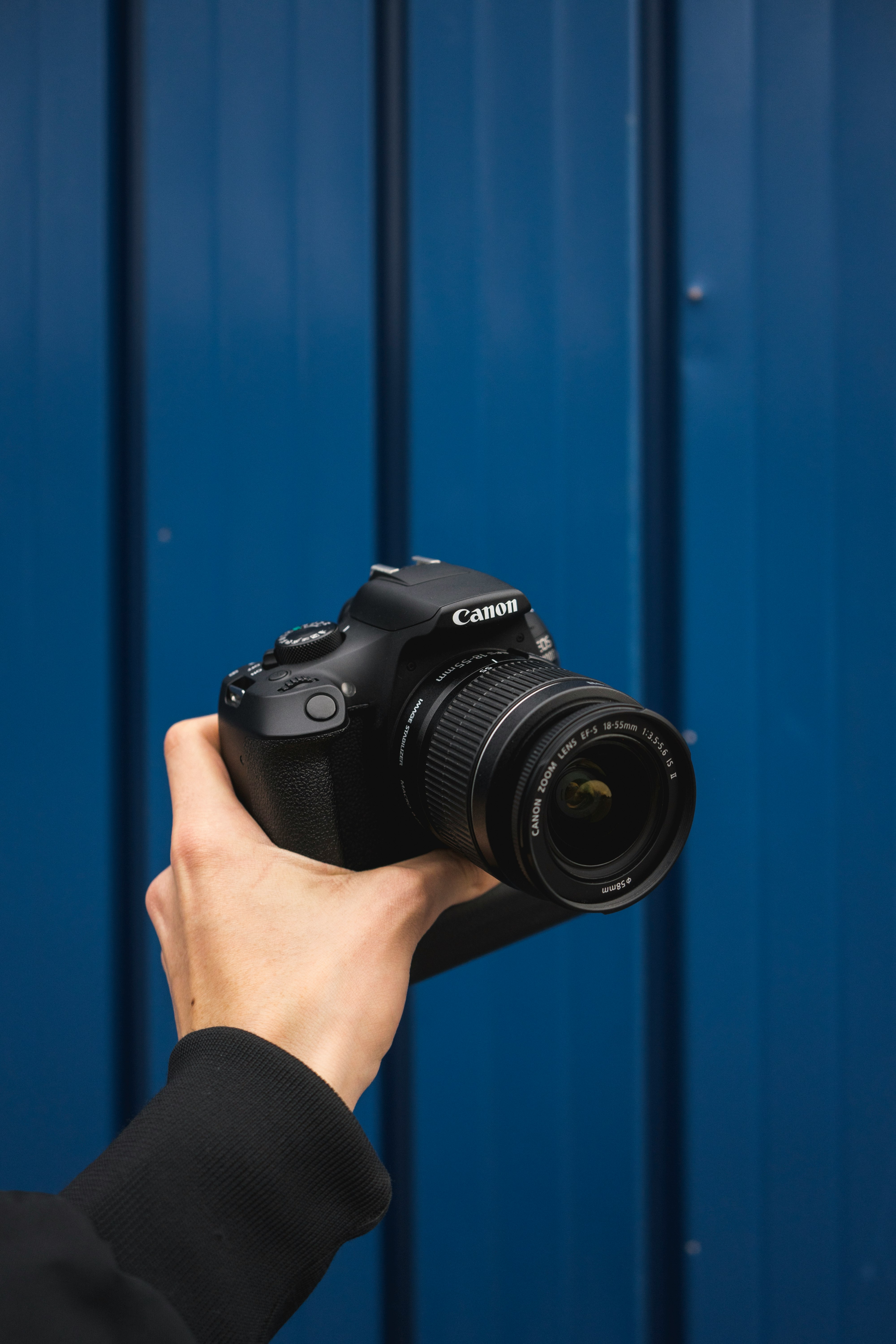 person holding black nikon dslr camera